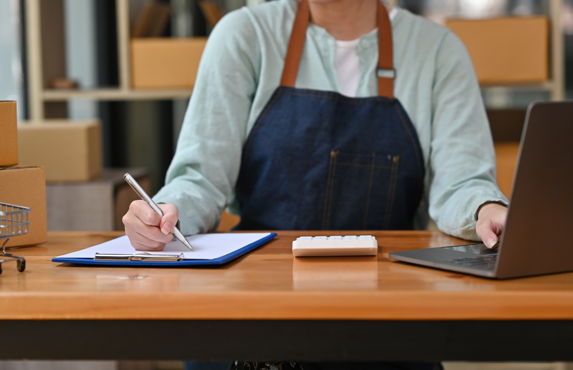 Person holding a blank sheet of paper while another gestures in the background