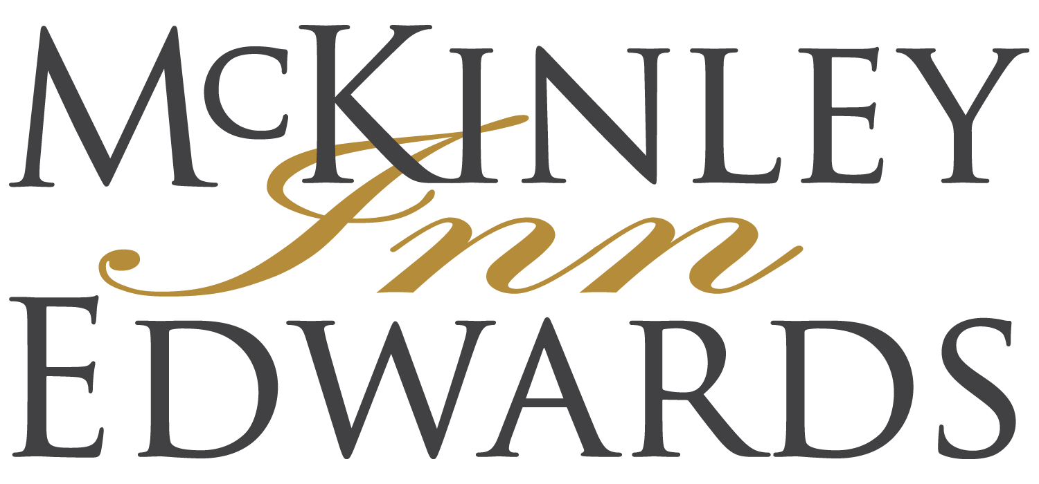 McKinley Edwards Inn logo in black and gold serif script