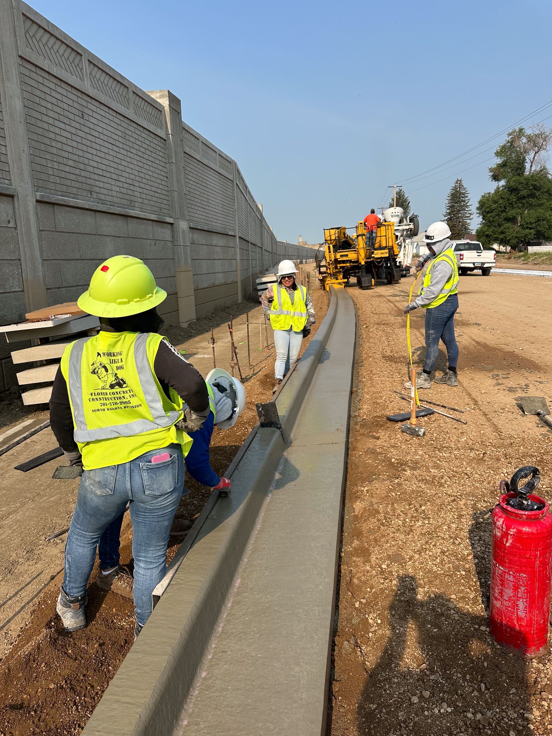 A group of construction workers are working on a road.