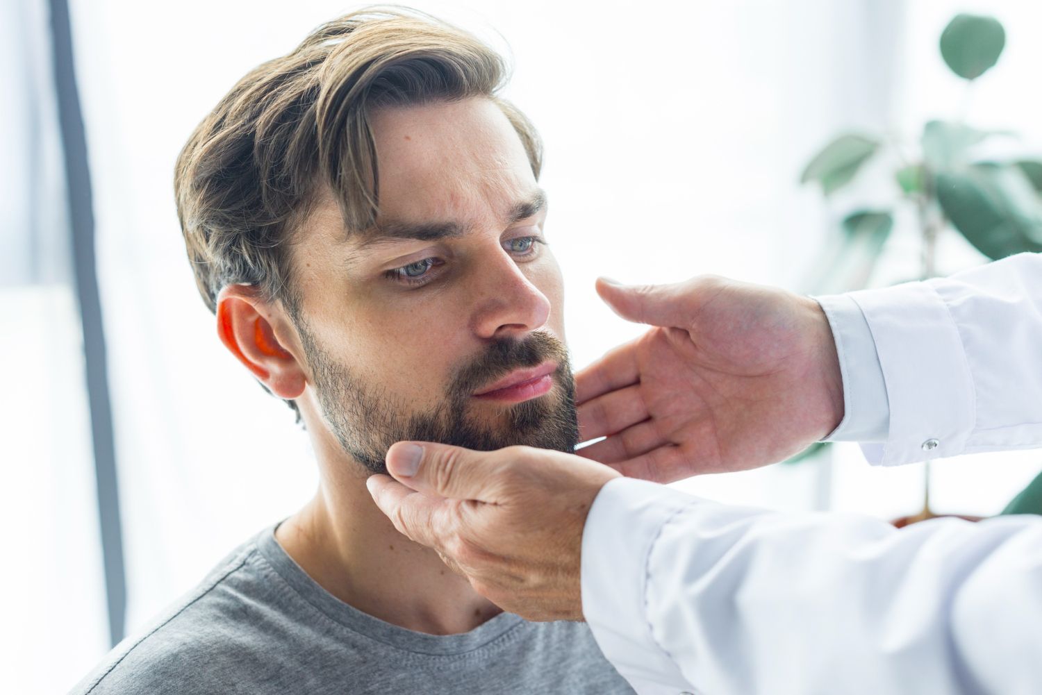 Doctor examining a man’s throat during a medical checkup
