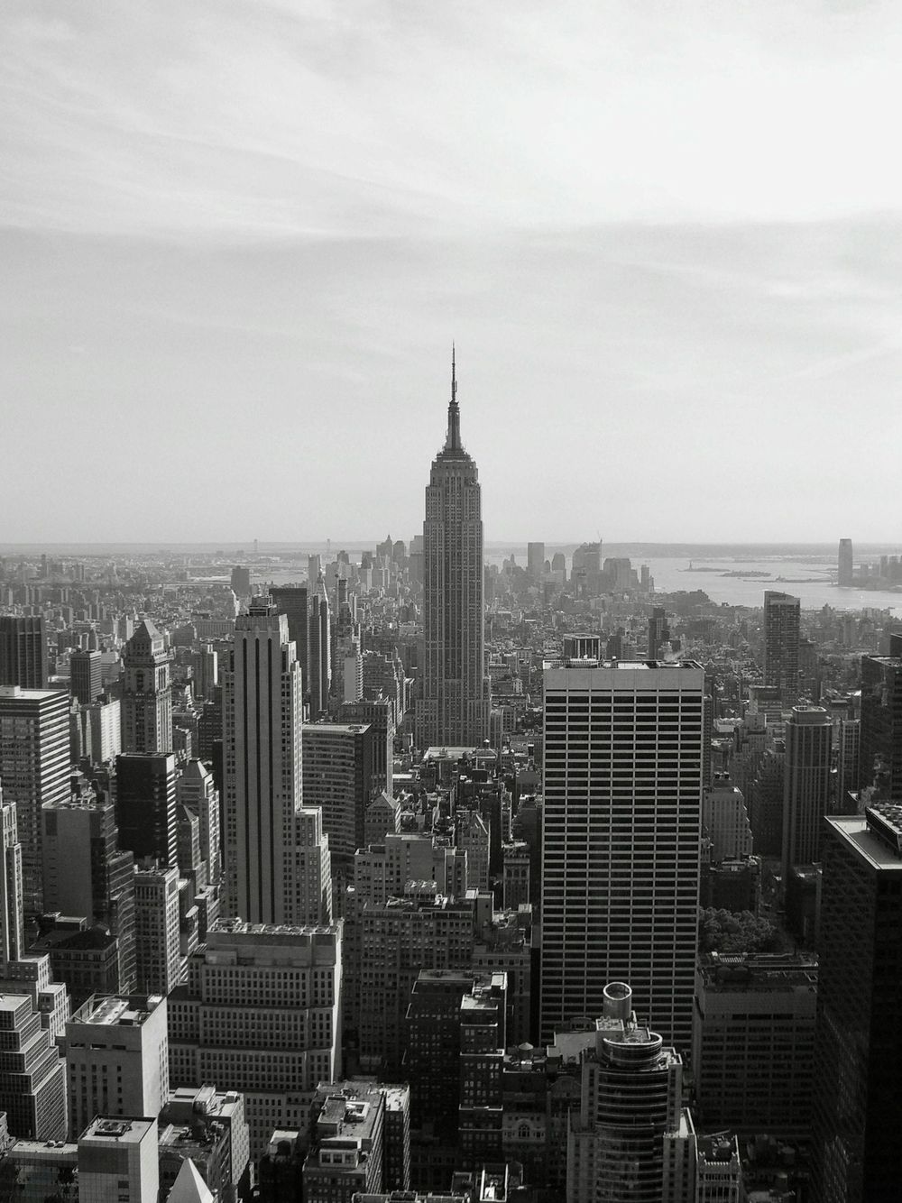 Black-and-white skyline of New York City with the Empire State Building centered in the distance