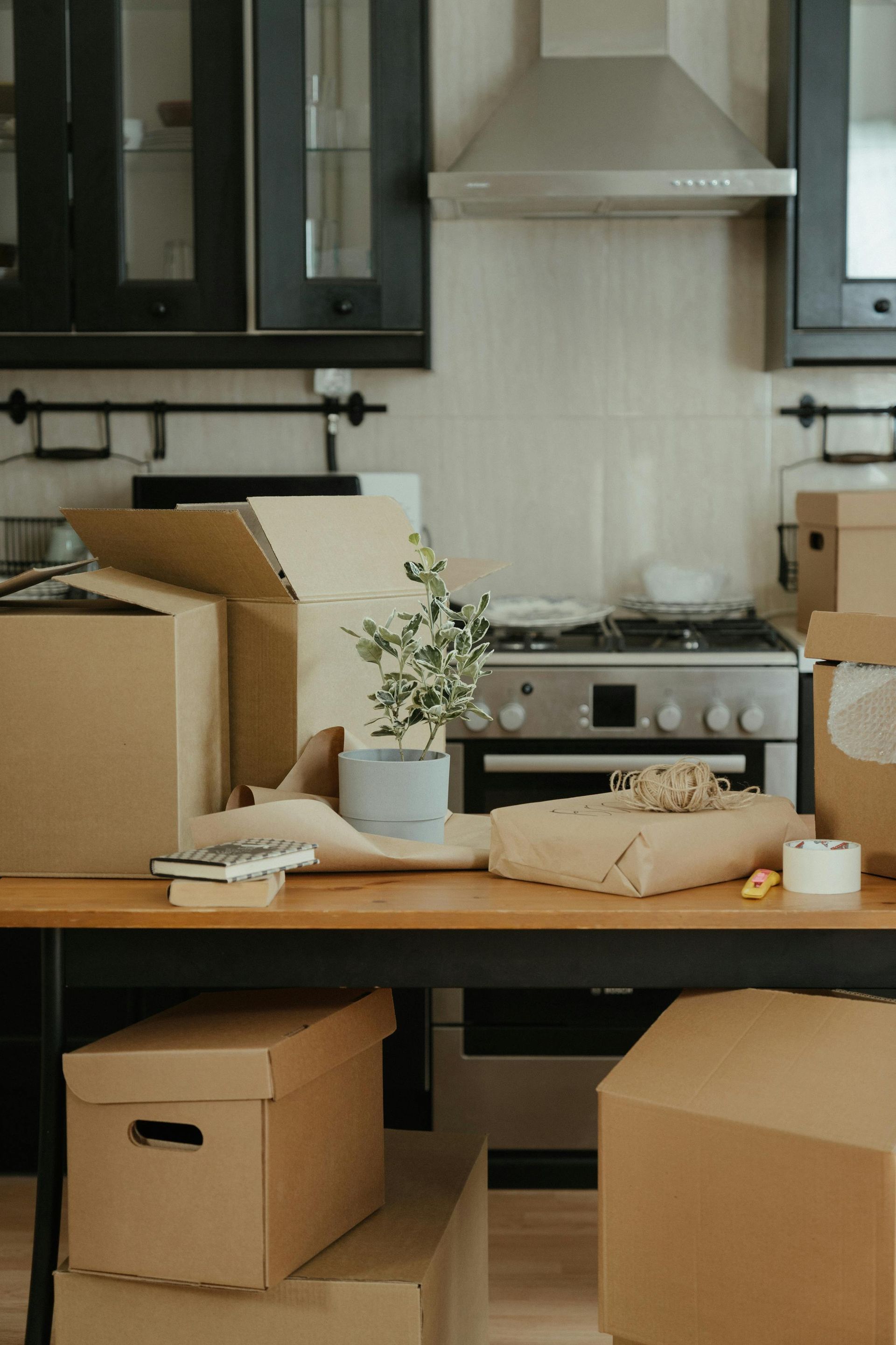 A room filled with a large pile of cardboard boxes, suggesting an unpacking or storage area.