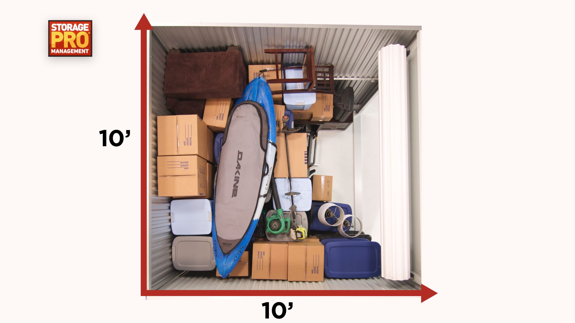 A storage unit, 10'x10', filled with boxes, furniture, a kayak, and other items.