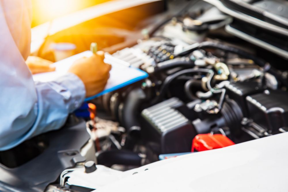 A Man is Checking a Car Insurance Check LIst in a Garage — Arafura Crash Repairs in Winnellie, NT