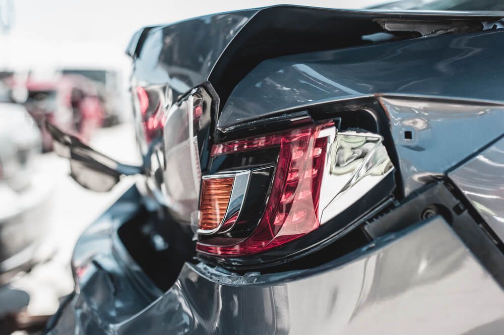 A Close Up of a Damaged Car With a Broken Tail Light — Arafura Crash Repairs in Palmerston, NT