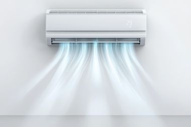 Wall-mounted air conditioner blowing cool blue air into a white room