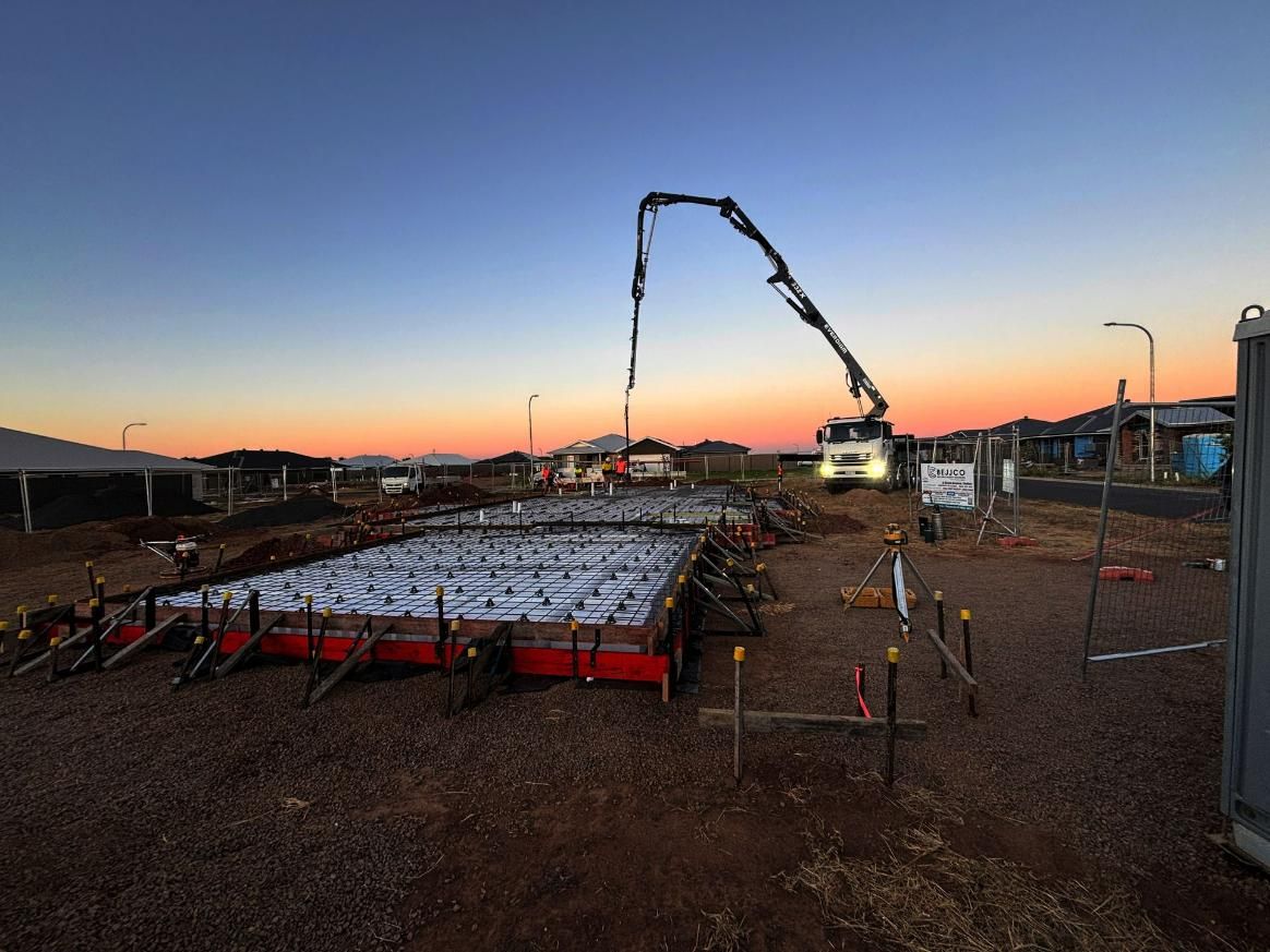 A Construction Site with A Crane Pumping Cement — Spencer's Landscape Construction & Concreting Pty Ltd in Dubbo, NSW