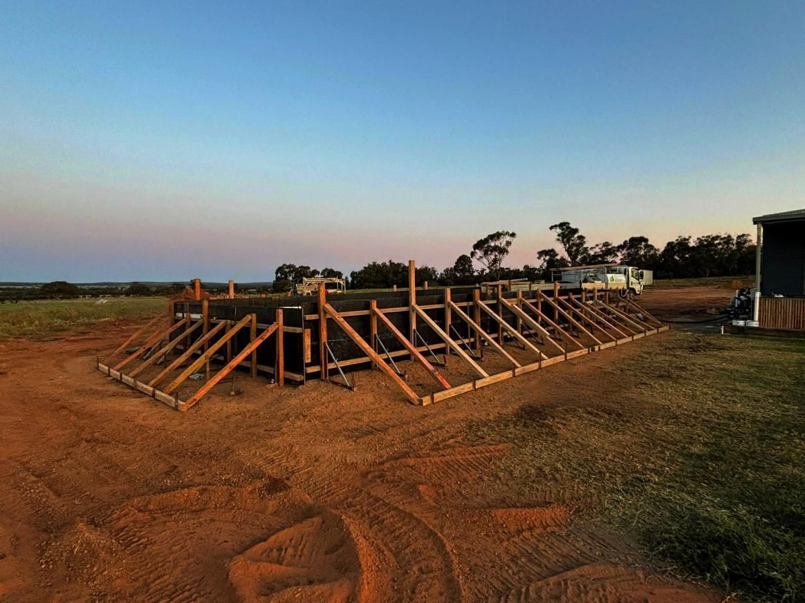 A Large Wooden Structure Is in The Middle of A Field — Spencer's Landscape Construction & Concreting Pty Ltd in Dubbo, NSW