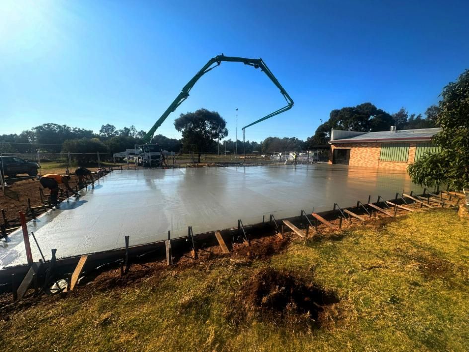 A Concrete Pump Is Being Used to Pour Concrete — Spencer's Landscape Construction & Concreting Pty Ltd in Dubbo, NSW