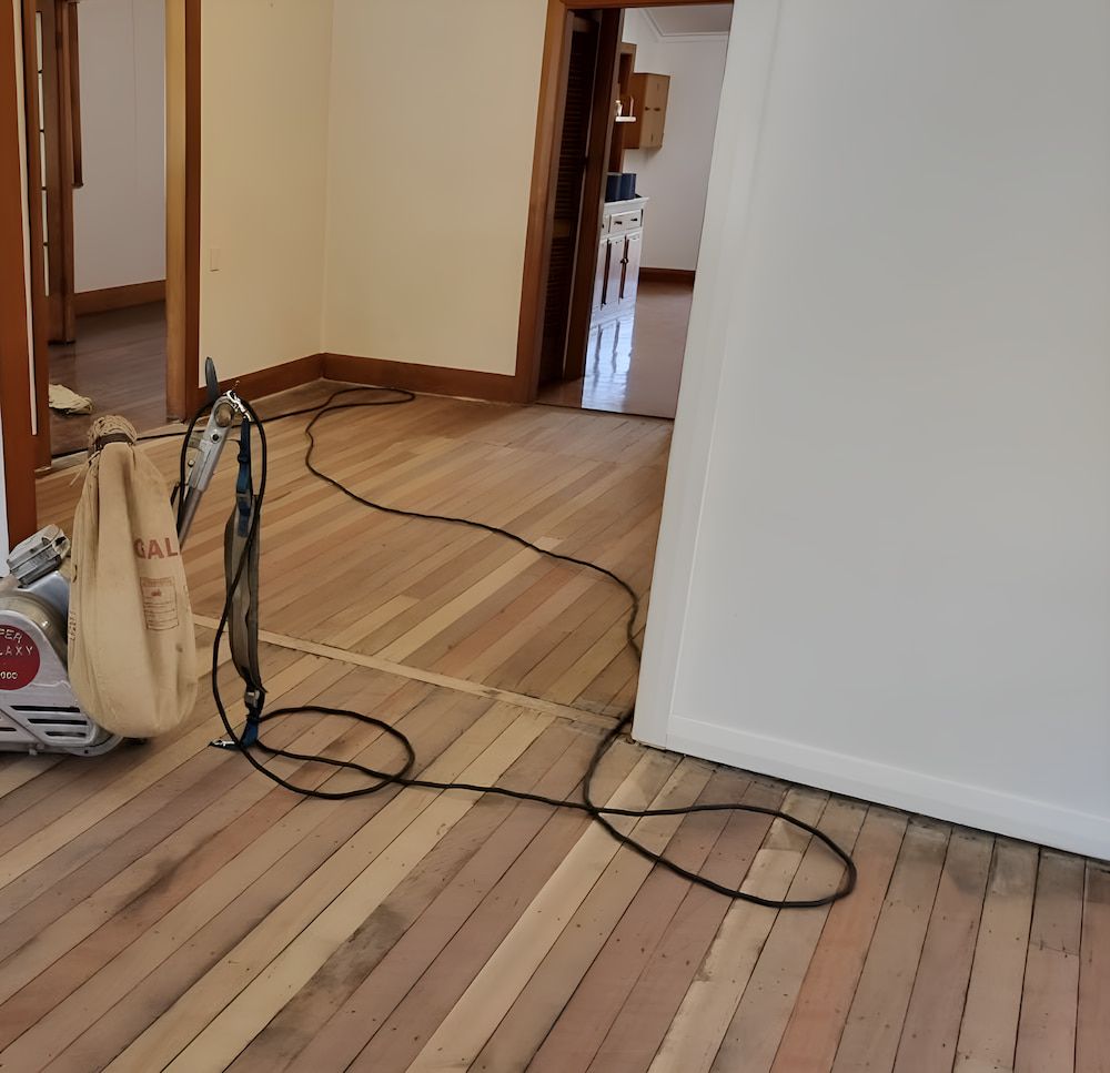 An Orbital Sander Is On The Wooden Floor — European Floor Sanding In Mount Louisa, QLD