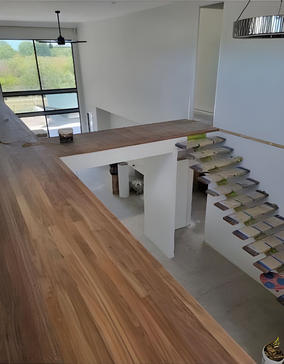 A Staircase in the Middle of the Room With a Wooden Floor — European Floor Sanding In Mount Louisa, QLD
