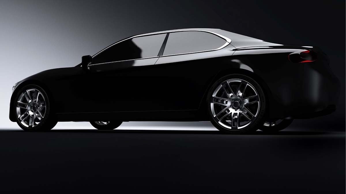 Black sports car, side view, shiny wheels, on a dark background.