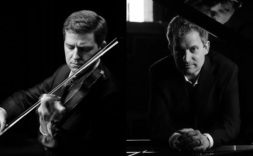 Two musicians in dark suits: one playing a violin on the left, the other leaning over a piano on the right, dark background.