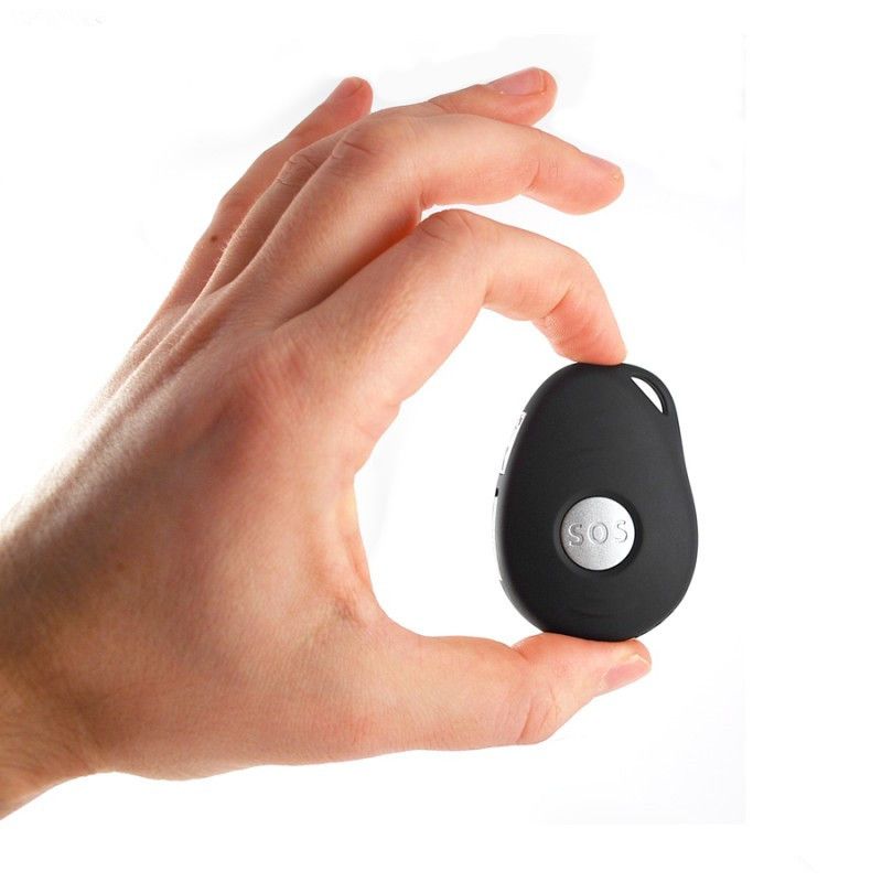 A hand is holding a small black sos device