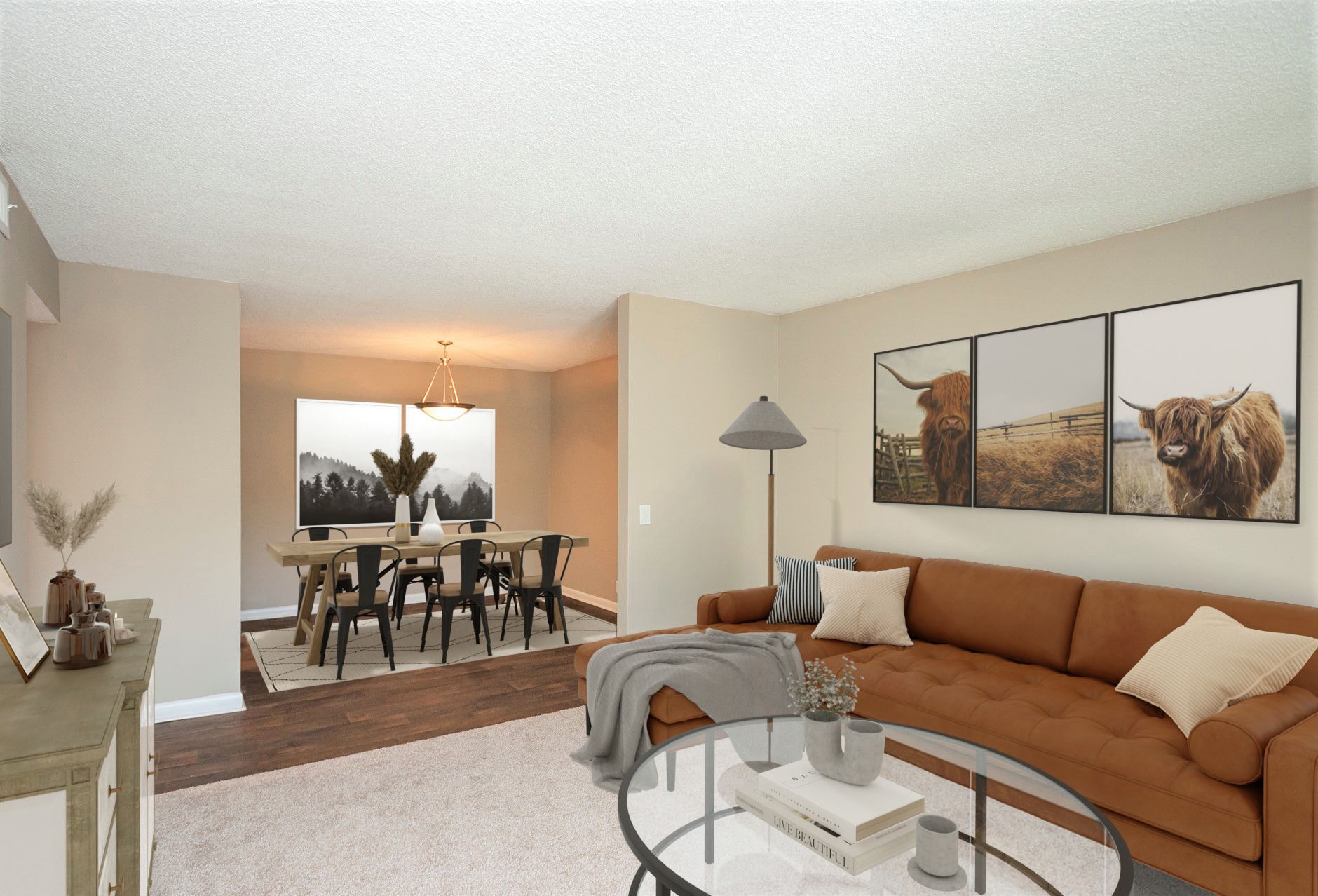 A living room with a brown sofa, a glass coffee table, and an adjacent dining area with a table and chairs.