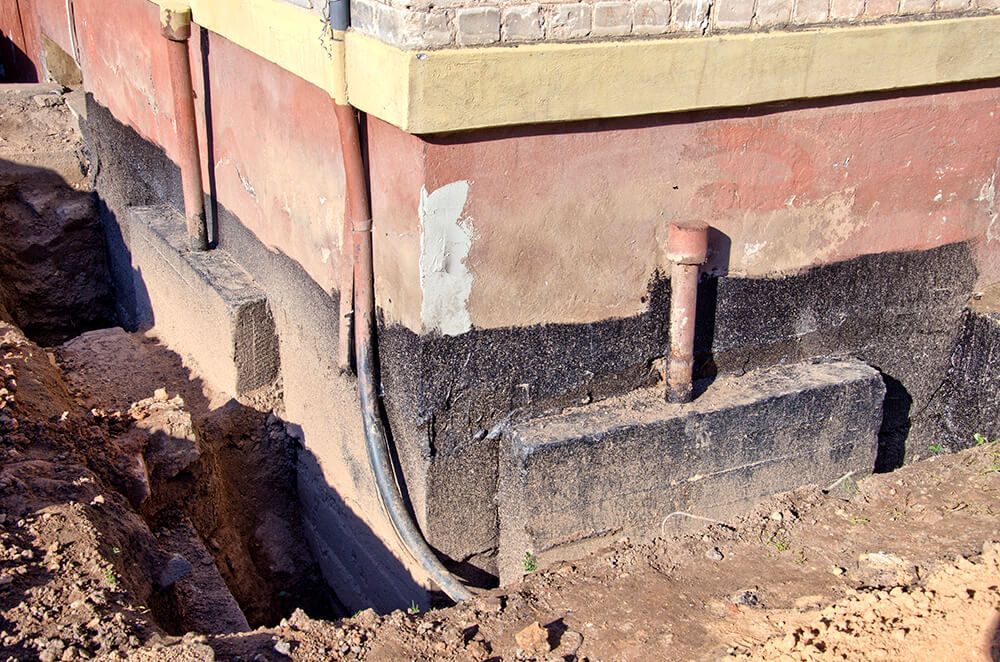 a brick building with a hole in the ground
