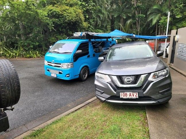 Two Cars Are Parked Next to Each Other on the Side of the Road — FNQ Windscreens in Redlynch, QLD