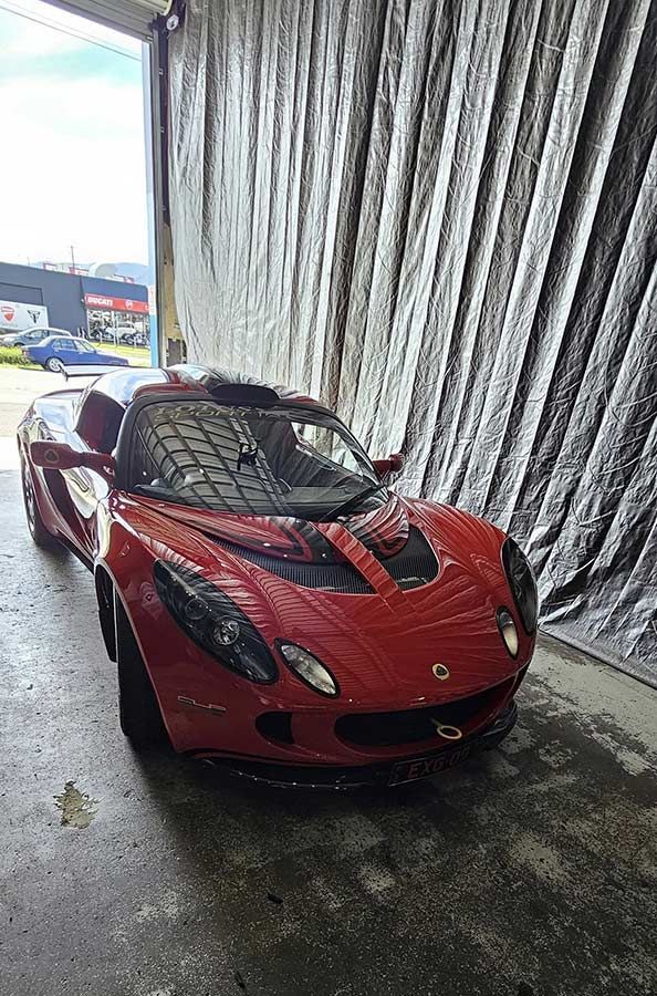 A Red Sports Car is Parked in a Garage — FNQ Windscreens in Bungalow, QLD