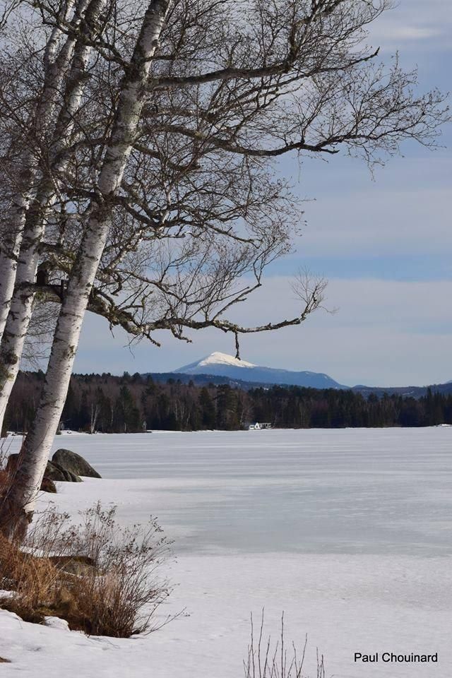 Snow covered Neal Pond with snow covered Mt Lafayette in the background