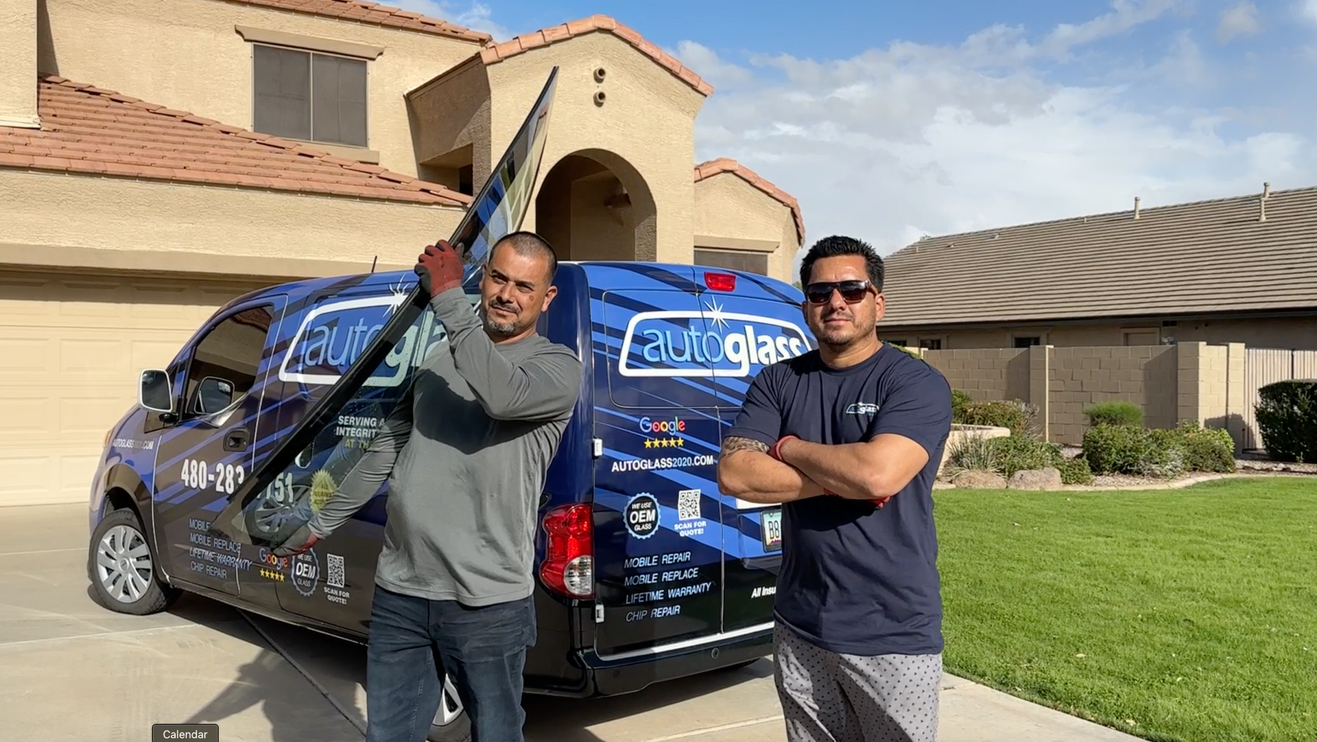 Two men are standing in front of a van in front of a house.