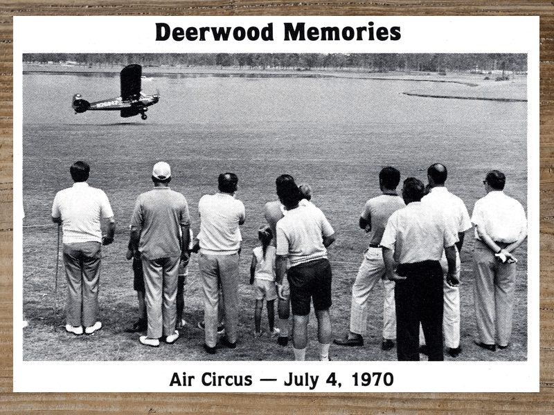 Crowd watches a biplane at an 