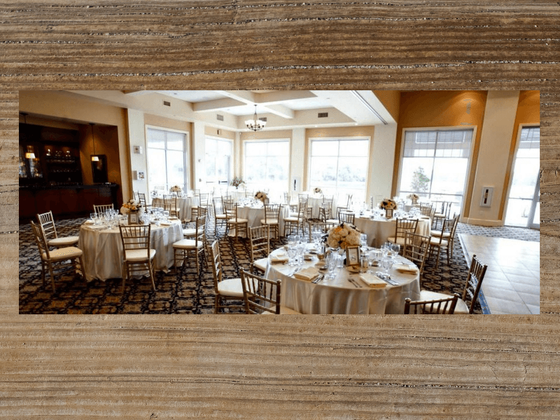 Ballroom with round tables set for a wedding reception.