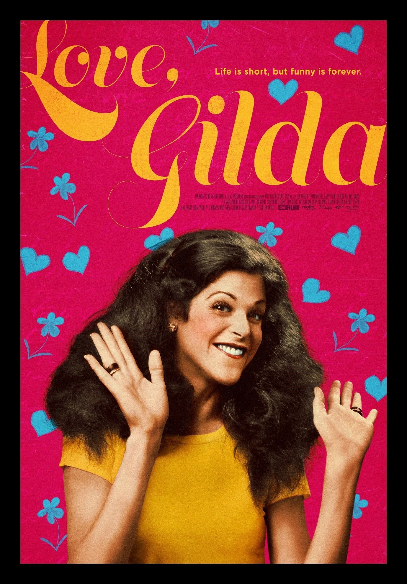 Woman in yellow top smiling and waving on a bright pink cover with hearts and the title “Gilda”