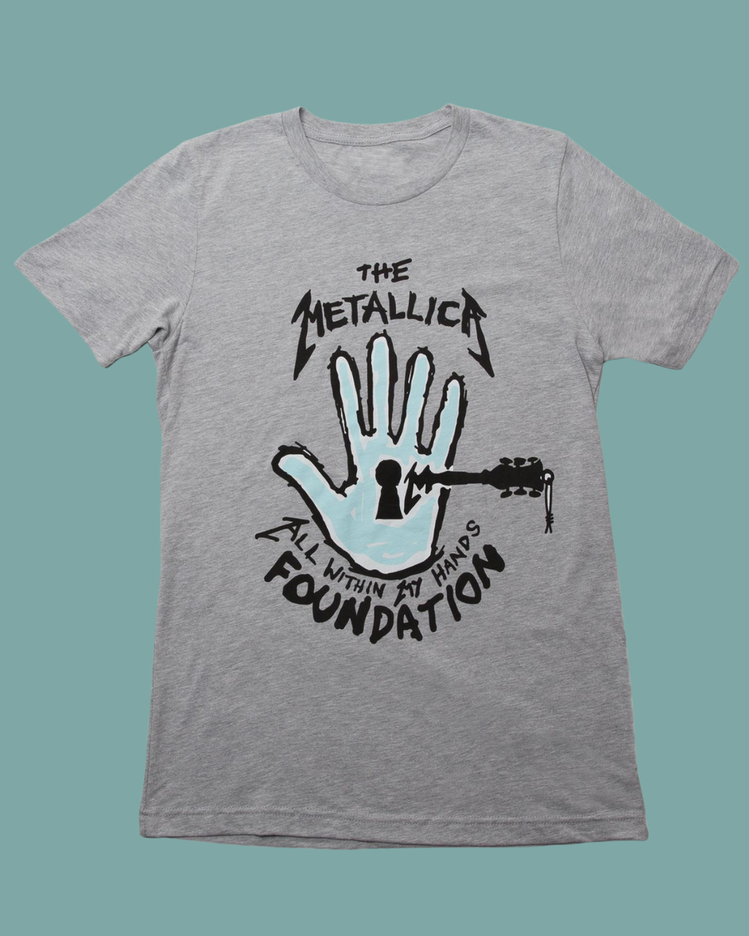 Gray T-shirt with The Metallica Black Album Foundation logo and hand graphic.