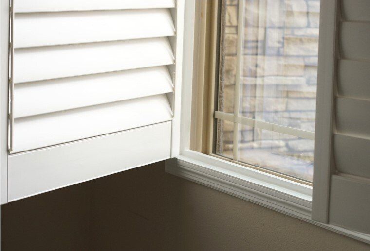 Close up of Plantation Shutter frame opened off window, with louvres closed.