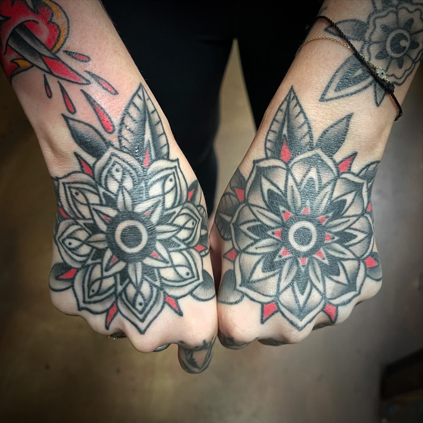 A person has a lot of tattoos on their hands