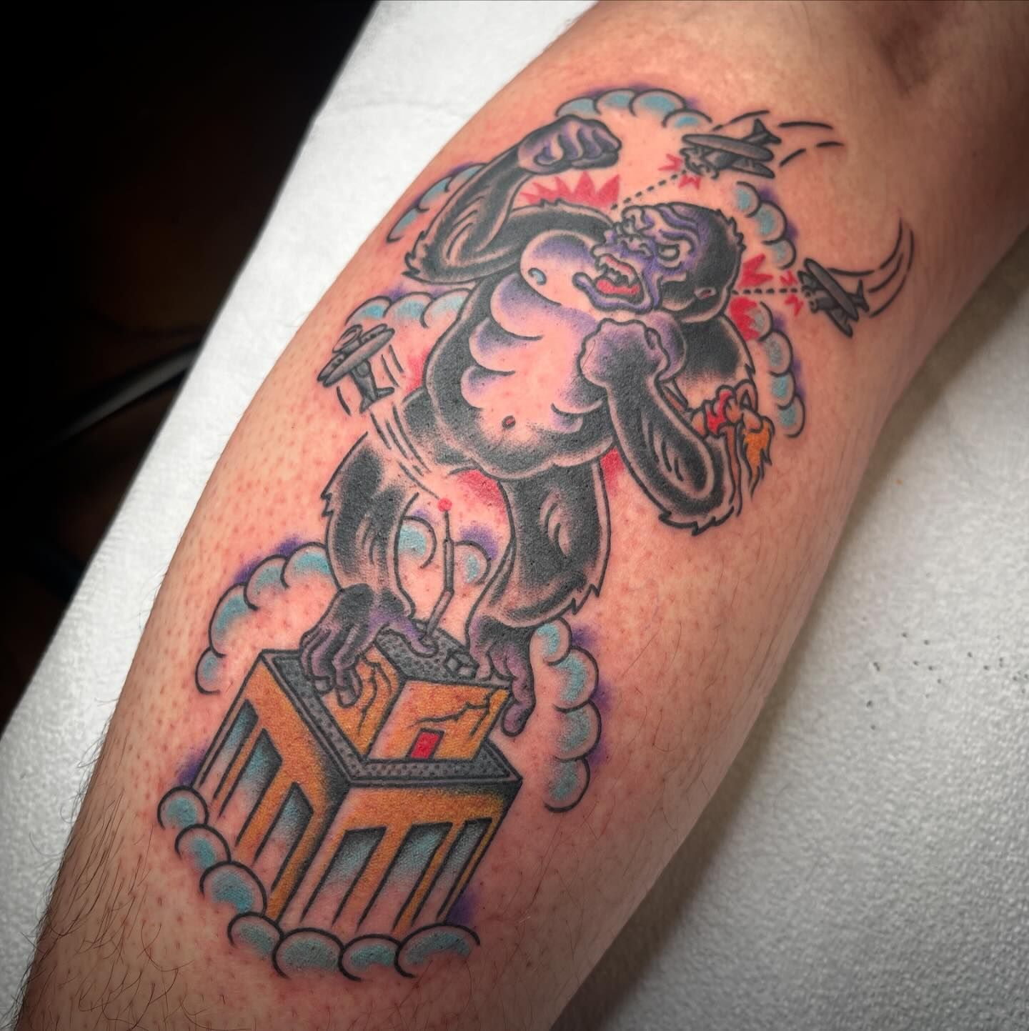 A man has a tattoo of a gorilla on his leg