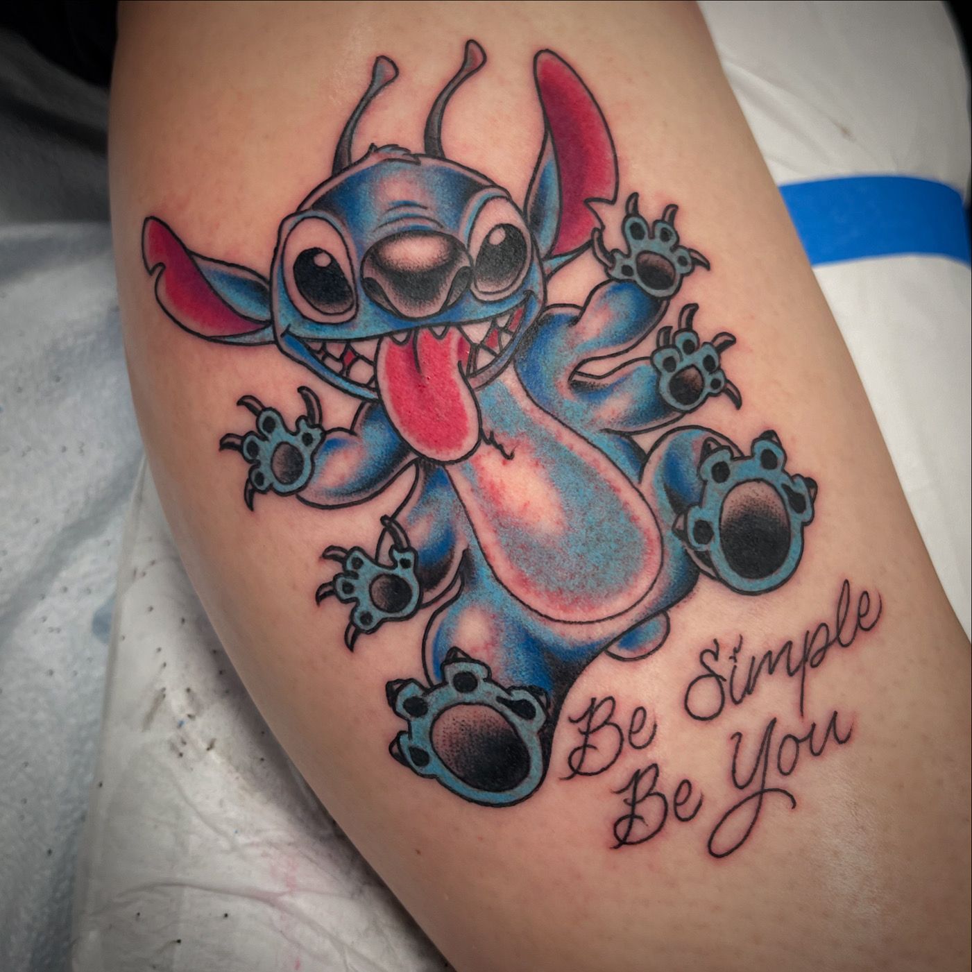 Tattoo of Stitch with tongue out and 
