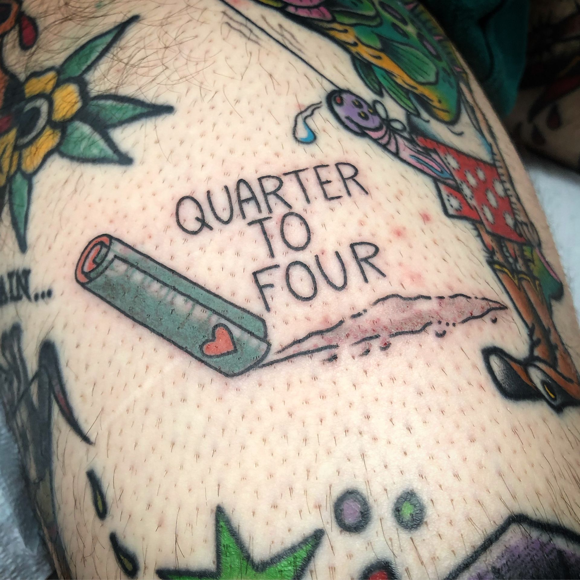 Tattoo of a rolled-up object with 