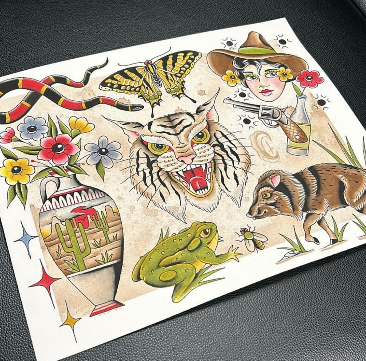 Tattoo flash sheet with various traditional designs: snake, butterfly, tiger, flowers, frog, cowgirl, pig, cactus vase.