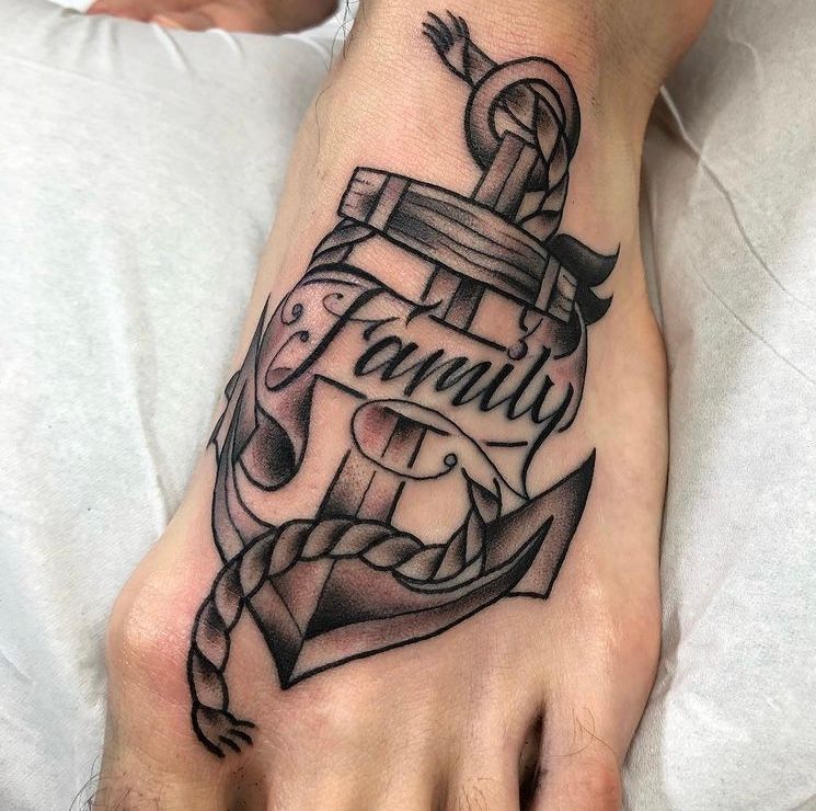 Tattoo of an anchor with the word 
