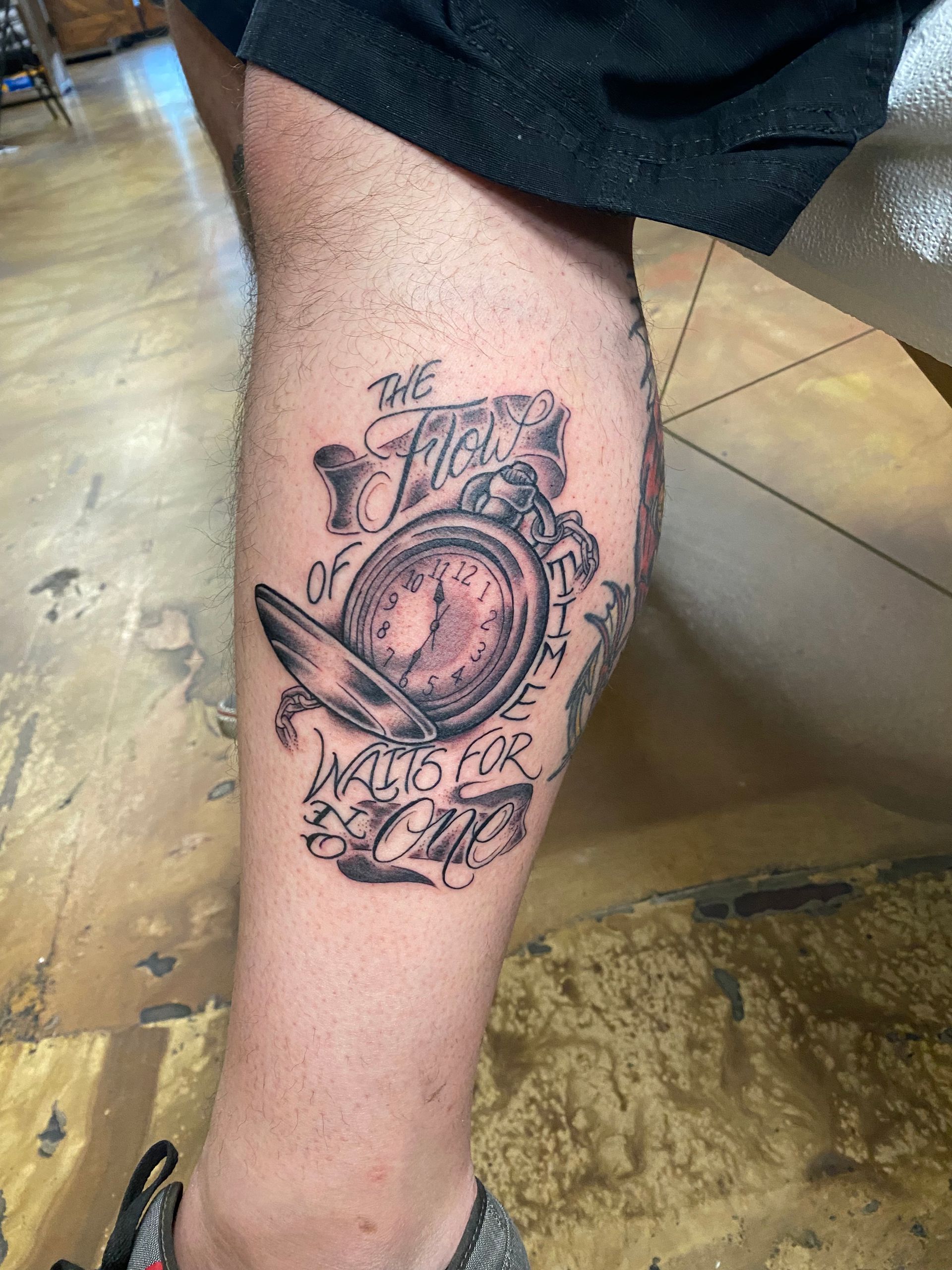 Tattoo on leg: pocket watch with text 