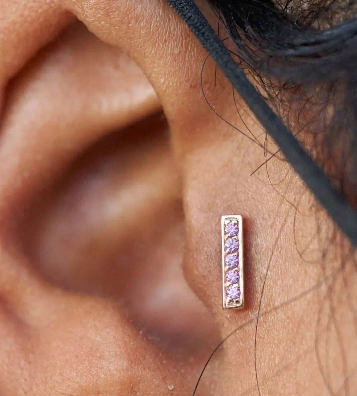 A close up of a person 's ear with a pair of earrings