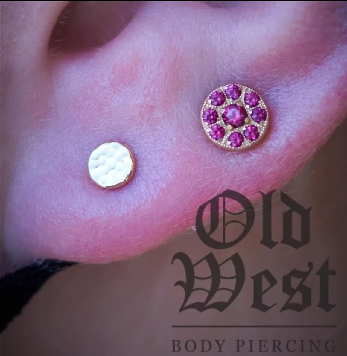 A close up of a person 's ear with earrings from old west body piercing