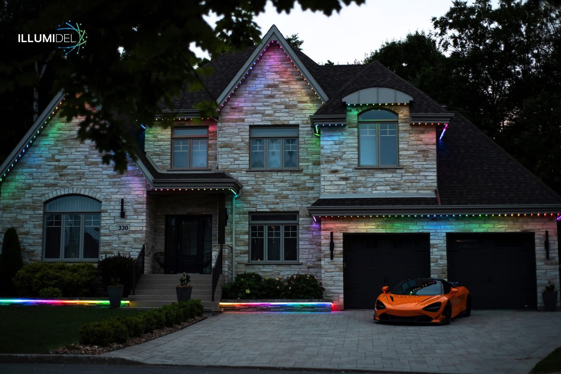 Two-story house with colorful lights and orange sports car in the driveway at dusk.