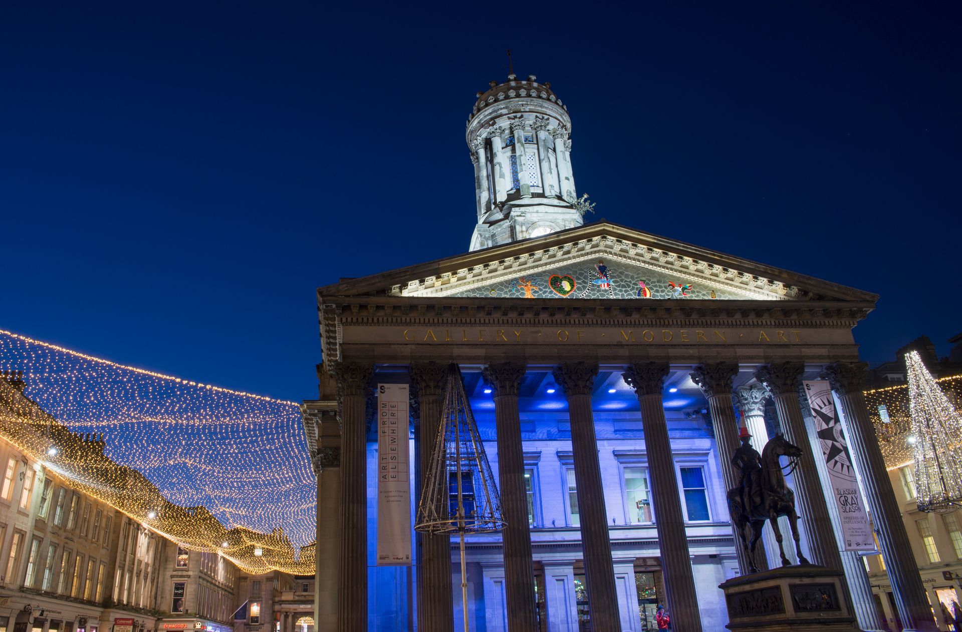 Glasgow Gallery of Modern Art at night, illuminated, with Christmas lights.