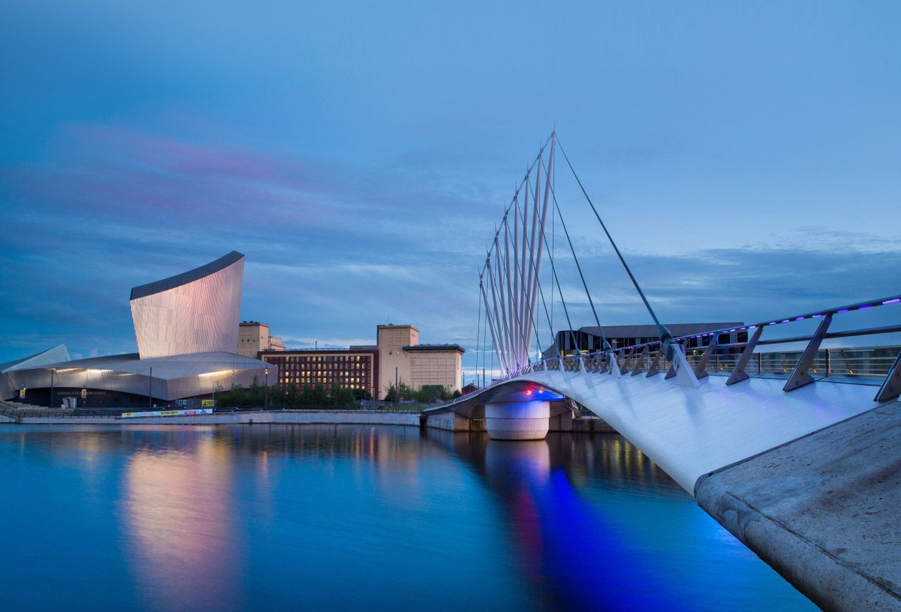 Imperial War Museum North building and bridge over canal at dusk.