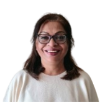 Woman wearing glasses, smiling, with dark hair, and a light-colored top.