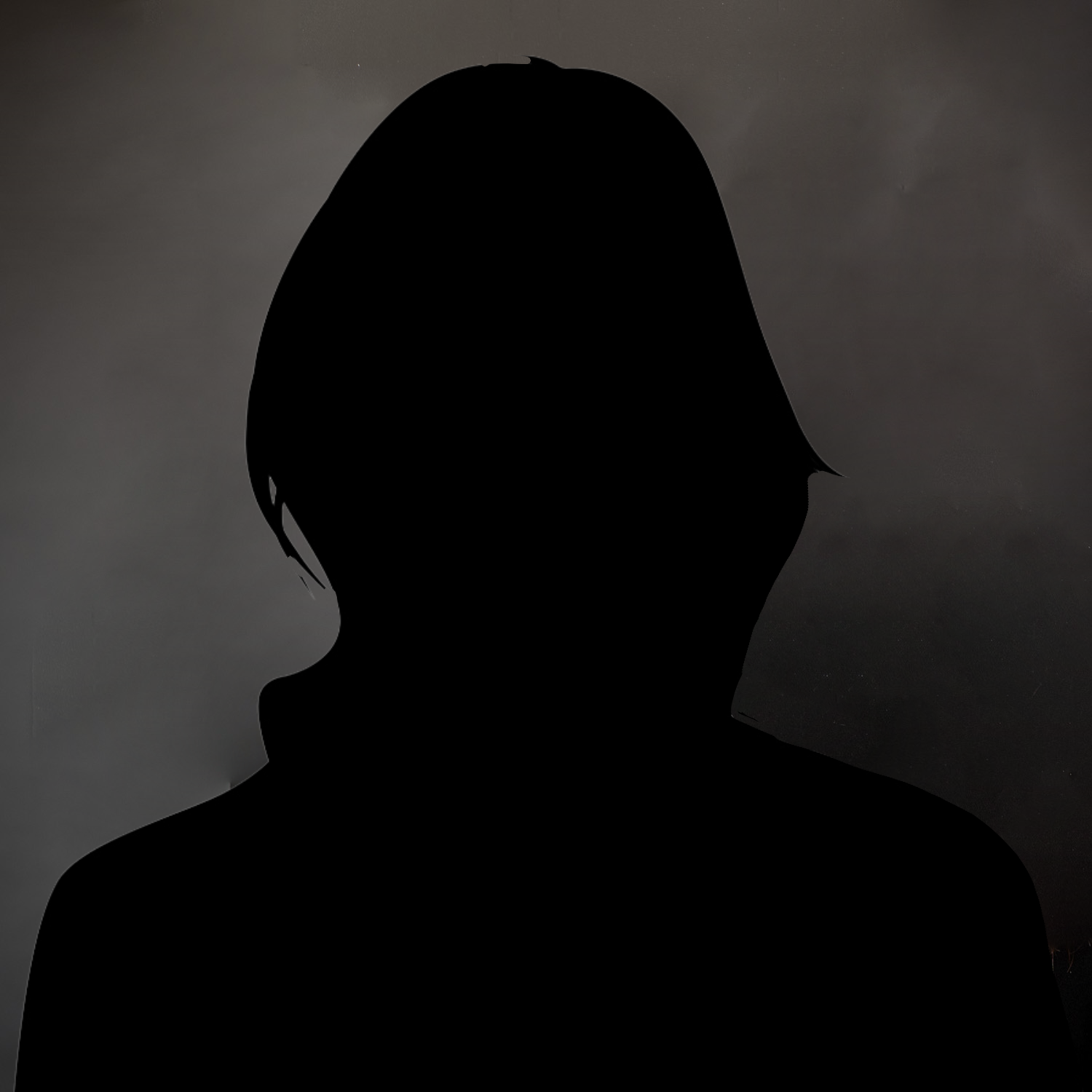 Silhouette of a person against a dark, mottled background.