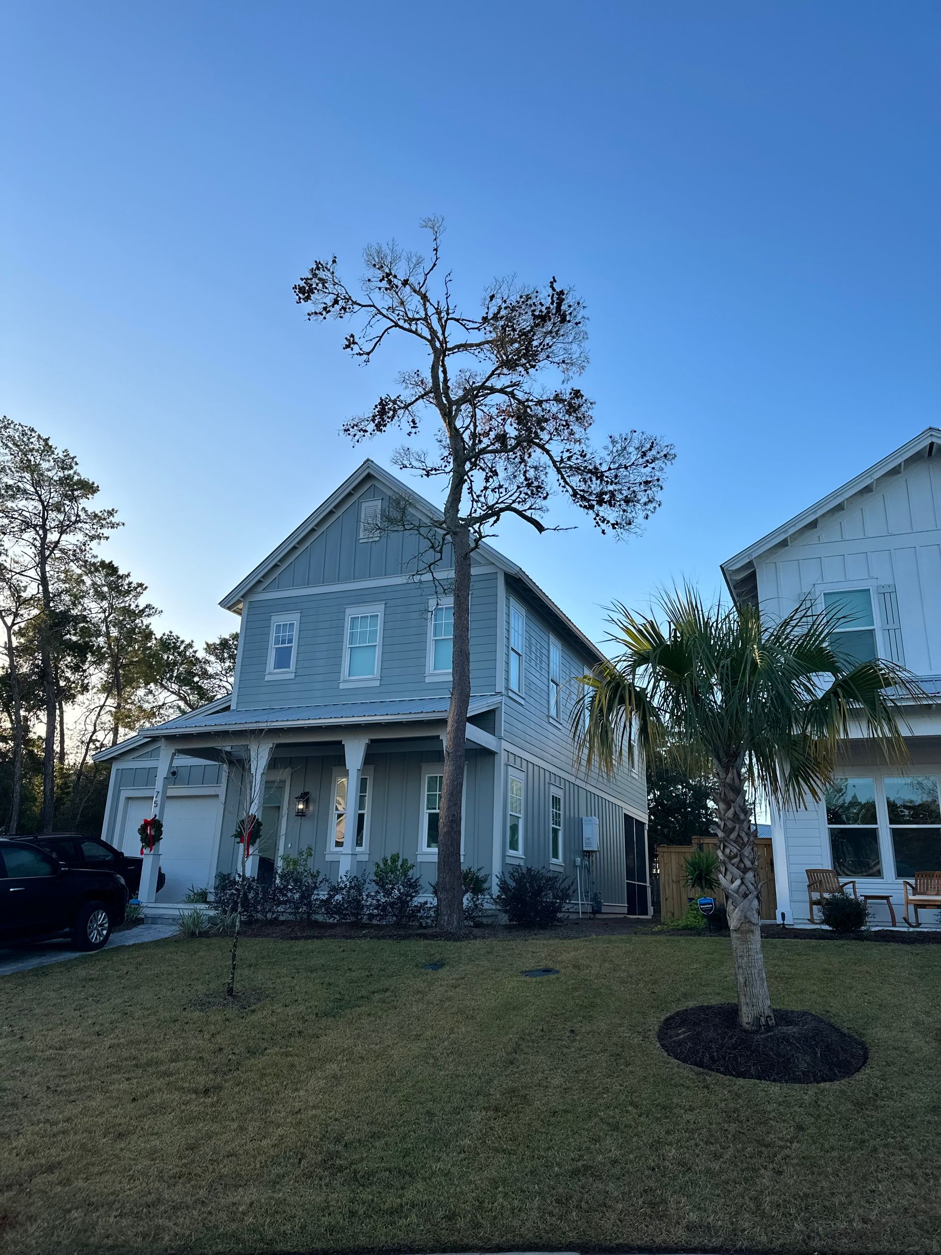Two-Story Light Blue House With Porch