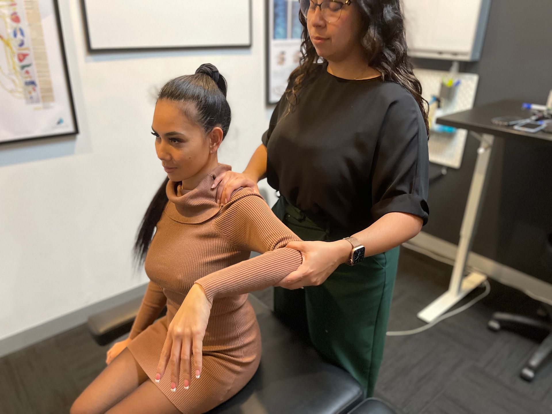 female having her shoulder pain treated