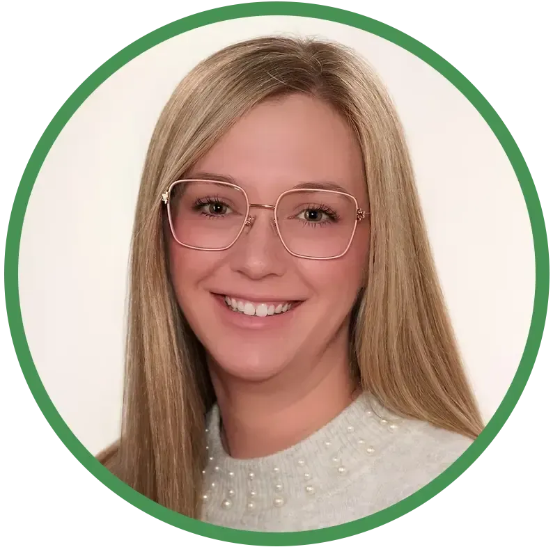 Portrait of a smiling person with long blond hair and glasses on a white background