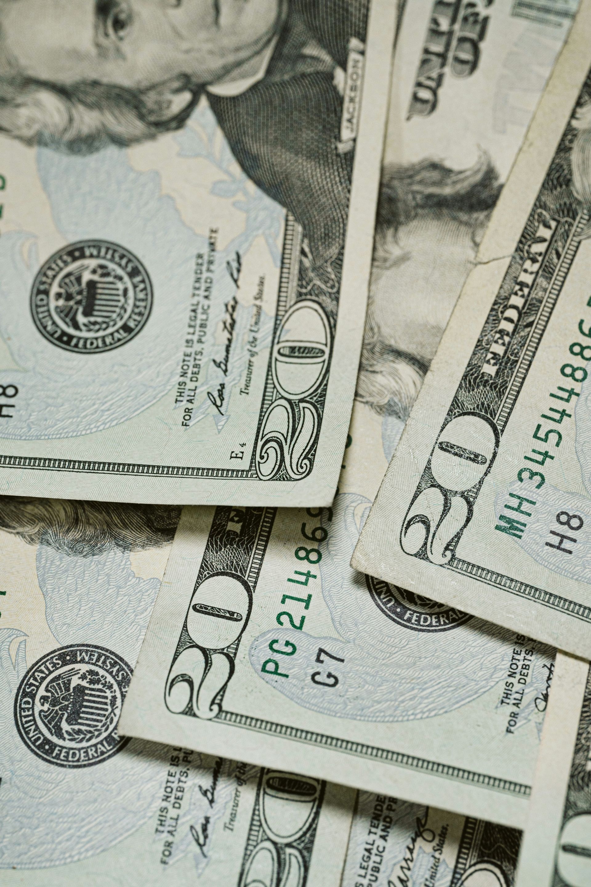 Stack of U.S. hundred-dollar bills spread in a close-up view.