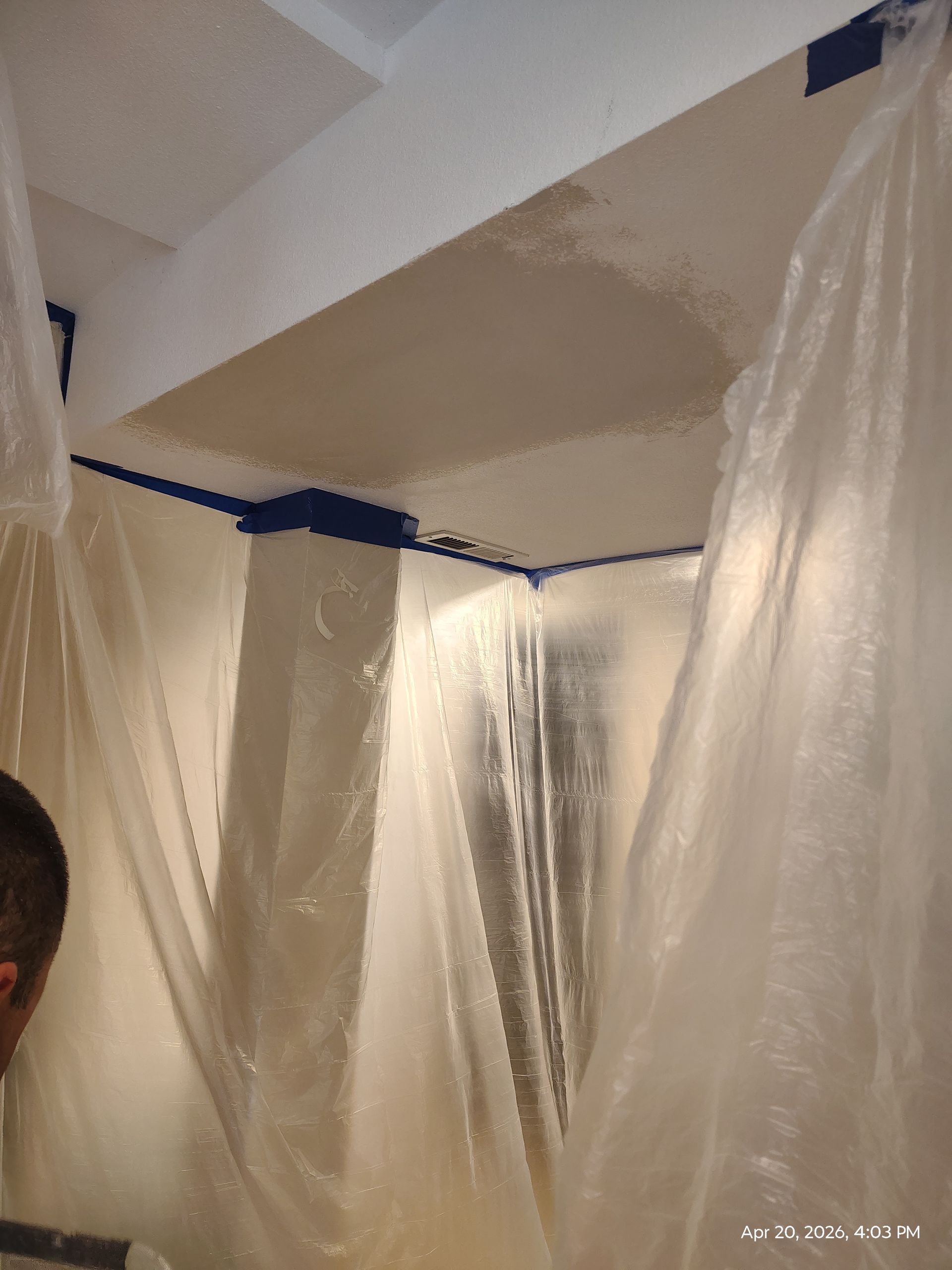 Room with plastic sheeting covering walls and ceiling during painting or renovation