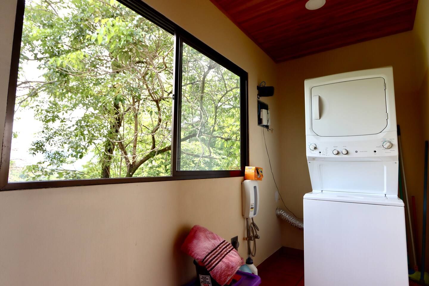 A laundry room with a washer and dryer and a window