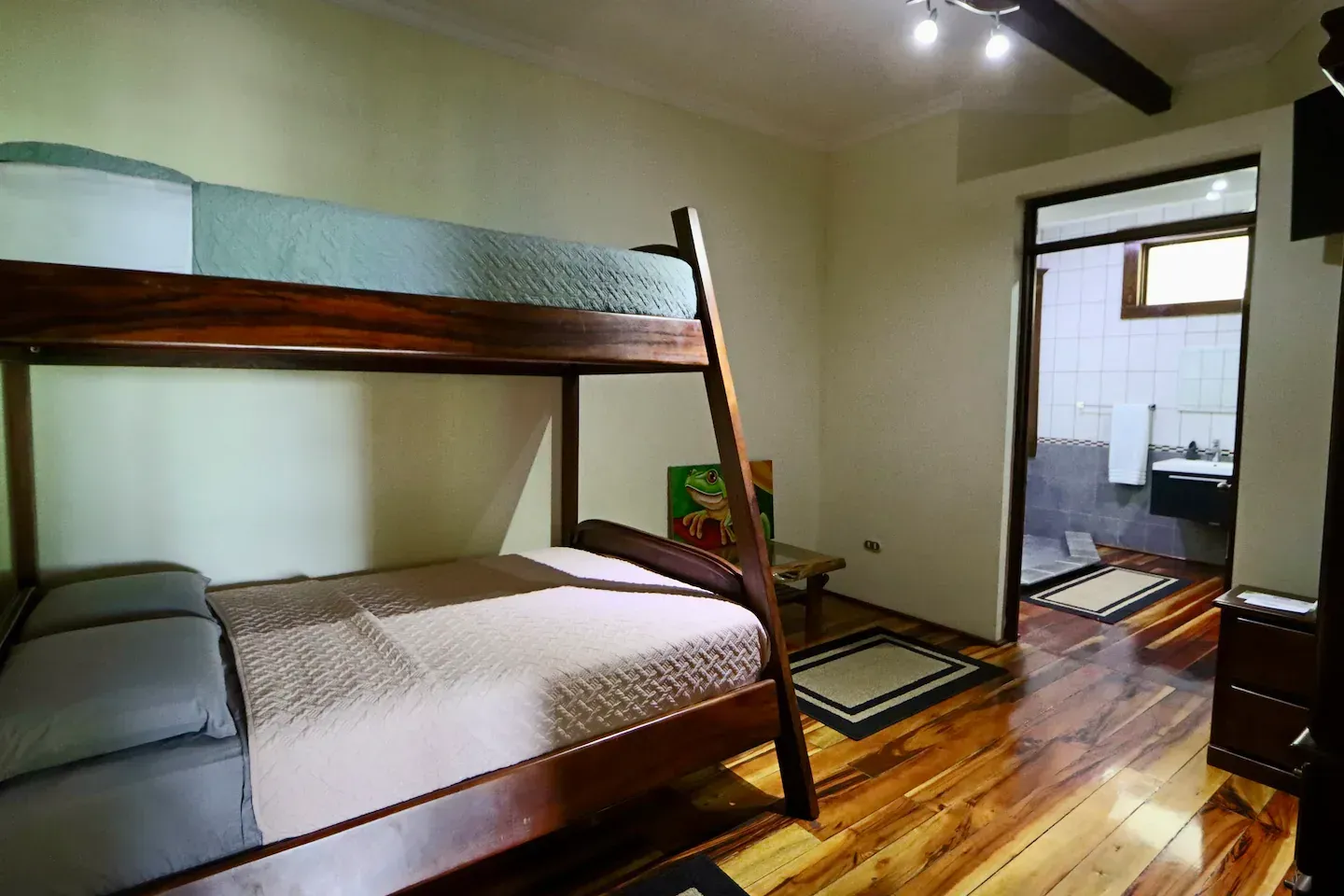 A bedroom with a bunk bed and a ceiling fan